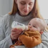 a woman feeding a baby